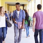 Students walking in high school hallway
