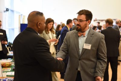 Neag education student, Kyle MacSuga, greets a school district representative during the career fair. 