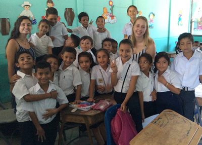 Neag School students Kelsey Iwanicki and Emily Baseler with schoolchildren in Costa Rica