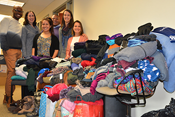 Faculty, staff, and students from the HESA program gathered with the donated items. 