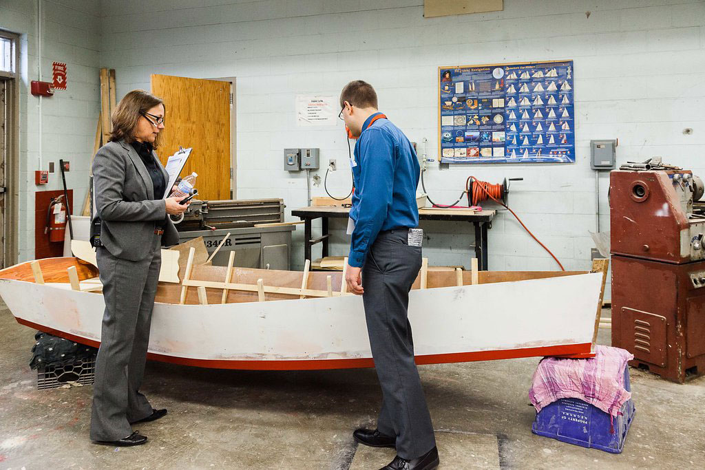 11:30 a.m. — Baker shows Angelo a boat building project, the first of its kind for the school. (Photo credit: Cat Boyce/Neag School)