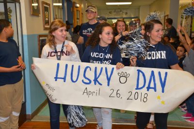 Neag School students lead the Husky Day parade.