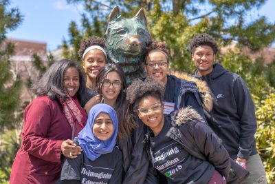 Student leaders from LID gather at the Husky statue.
