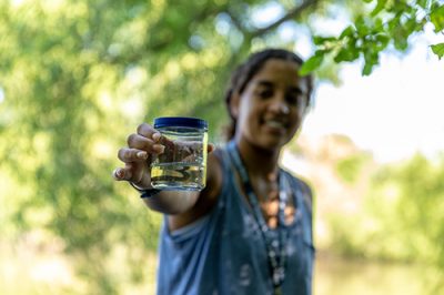 Sarida, a student from Austin, Texas, goes after a leech to use in a microbiology experiment during the Young Scholars Summit., a three-week mentoring program for high school students. (Frank Zappulla for UConn)