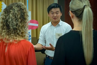 Photo caption: Ellijah Tateishi, shares his insights on available resources, with Ann Traynor, director of advising and certification, and René Roselle, interim director for teacher education. 