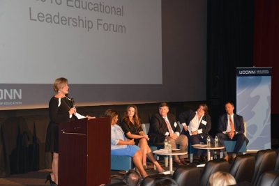 Sarah Barzee, chief talent officer with the Connecticut State Department of Education (CSDE) and Executive Leadership Program alumna, gives welcoming remarks. Also pictured are panelistsPatricia Garcia, Windham Public Schools superintendent; Lisa Lamenzo, CSDE turnaround bureau chief and current UCAPP student; Jim Messina, Clinton Public Schools literacy specialist and current UCAPP student; Jennifer Michno, Neag School clinical instructor and UCAPP alumna; and Nathan D. Quesnel, East Hartford Public Schools superintendent and IB/M alumnus. 