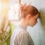 Image of student looking frustrated at a classroom blackboard (ThinkStock photo)