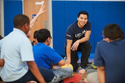 Husky Sport mentors lead middle school students in exercise.