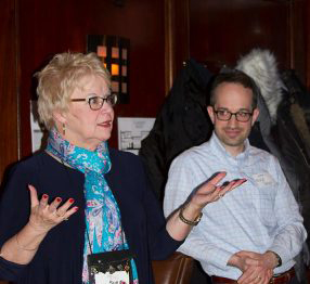 Sue Saunders sits, gesturing.