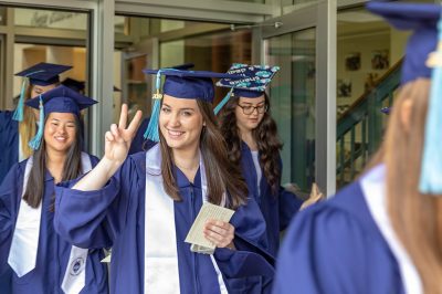 Neag School Class of 2019 grads leave the Gentry Building on their way to the start of the Undergraduate Commencement ceremony.