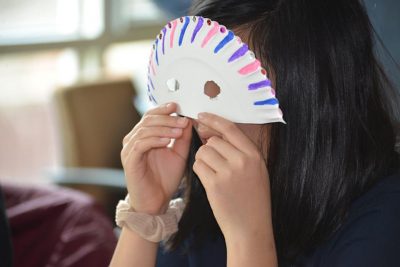 A student from Ellington (Conn.) High School enjoys the mask-making session during the visit to UConn. 