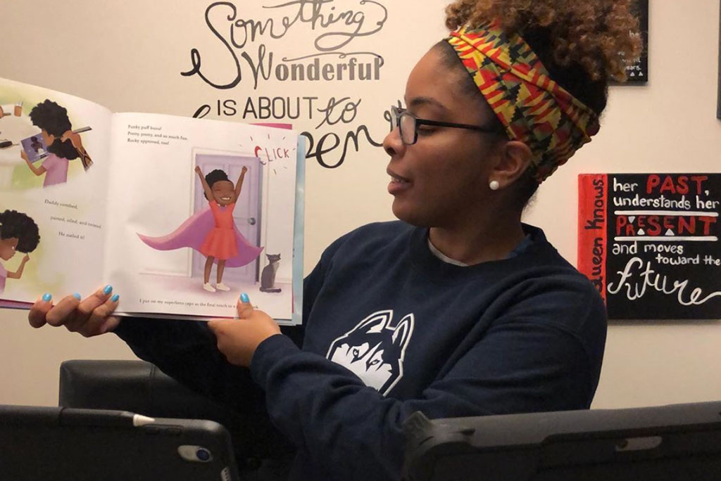 Tracey Ann Lafayette record herself reading a book aloud, which she shares online with her students.