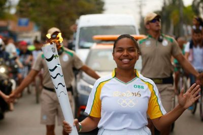UConn alumna Pauline Batista Souza da Silva carries the torch at the 2016 Olympic Games in Rio.