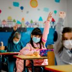 Kids wearing masks in classroom.