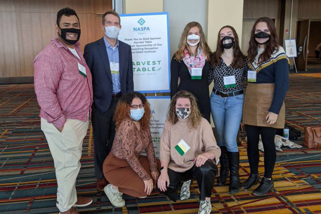 Group of people wearing masks at a conference. 