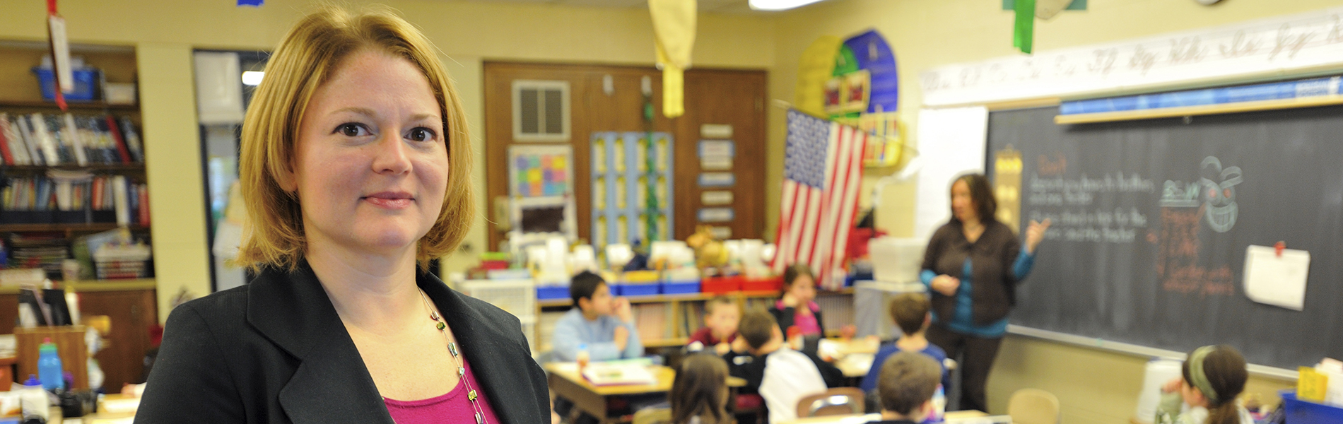 Sandra Chafouleas holds a book in a classroom.