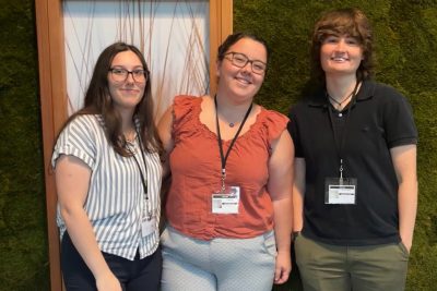 Three graduate students gather at a conference.