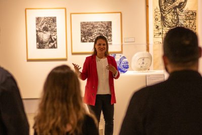 Female educator presents at museum event. 