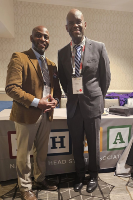 Two Black males gather at a conference.