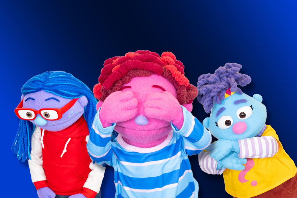 Three puppets pose in front of a blue background. [Links to UConn Today website]