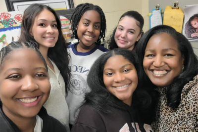 Group of smiling females of color.